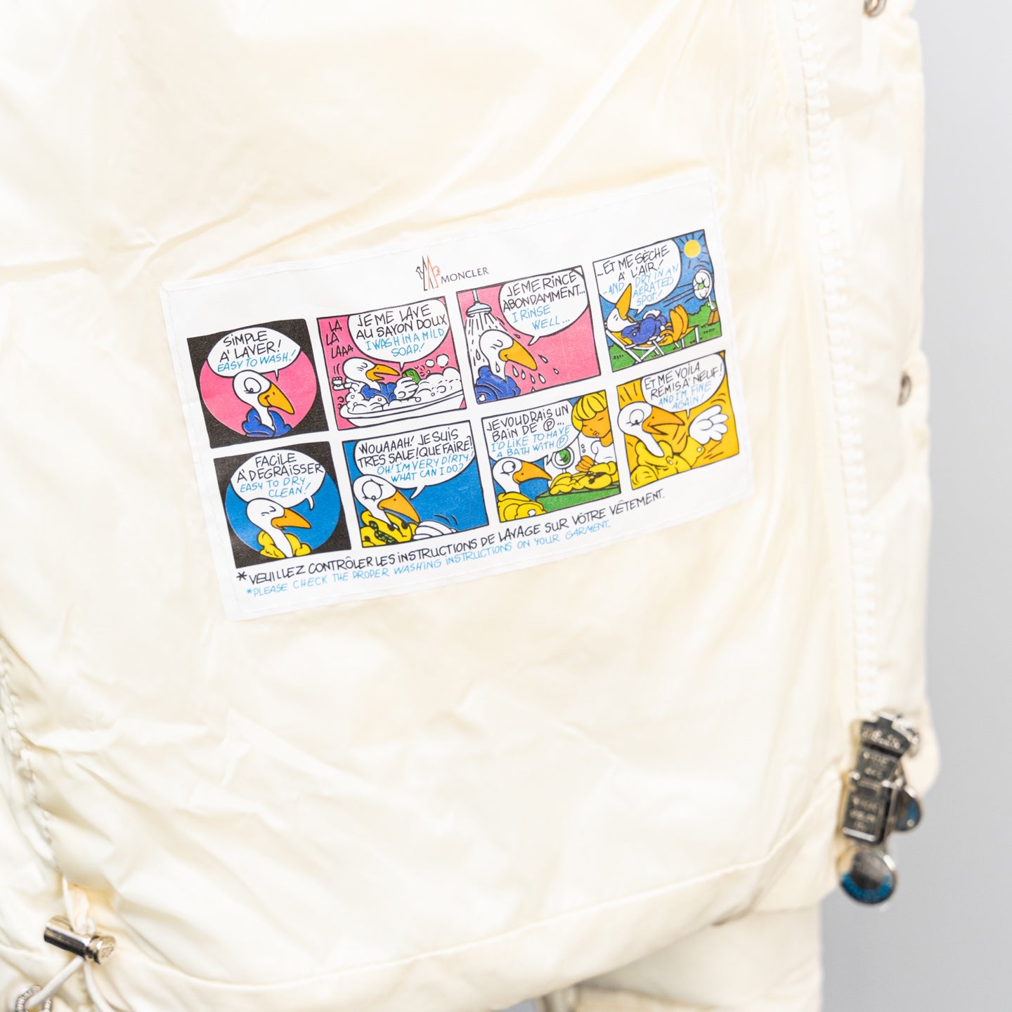 Moncler white puffer jacket side graphic patch with zipper pull