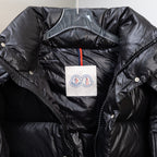Moncler dark puffer jacket front detail, zip placket and logo patch