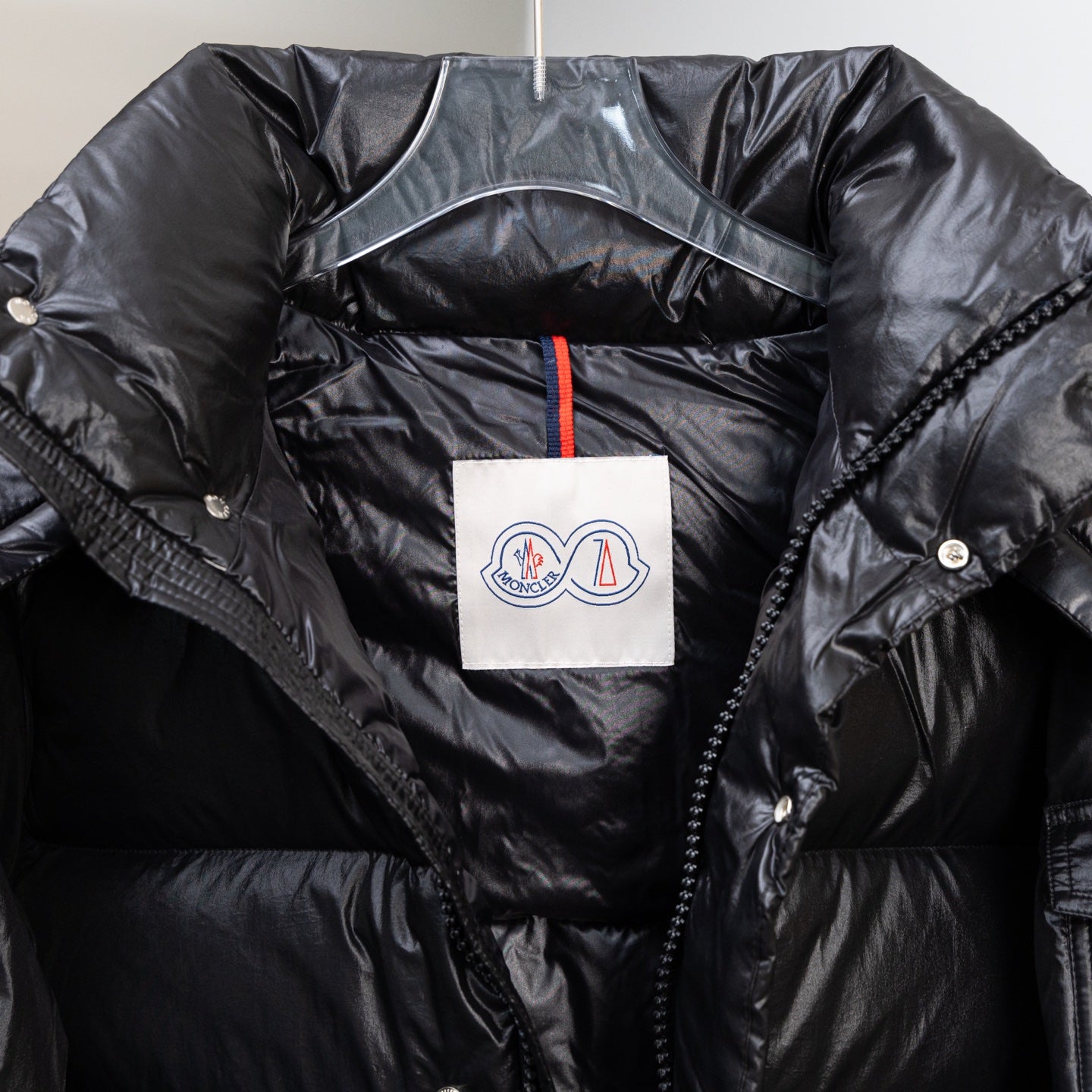 Moncler dark puffer jacket front detail, zip placket and logo patch