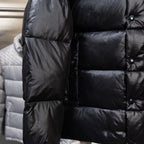 Moncler dark puffer jacket sleeve and torso close-up with quilted baffles