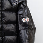 Moncler dark puffer jacket side view with chest pocket and button tabs