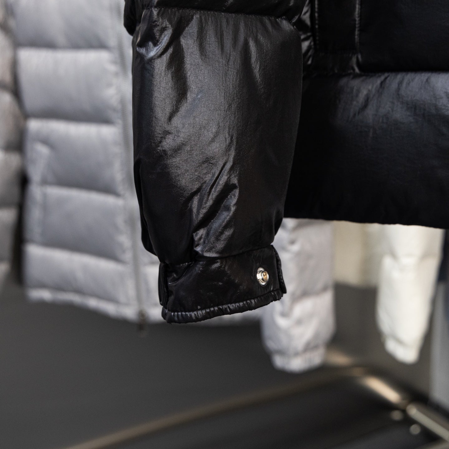 Long puffer jacket cuff with snap button and gathered sleeve hem