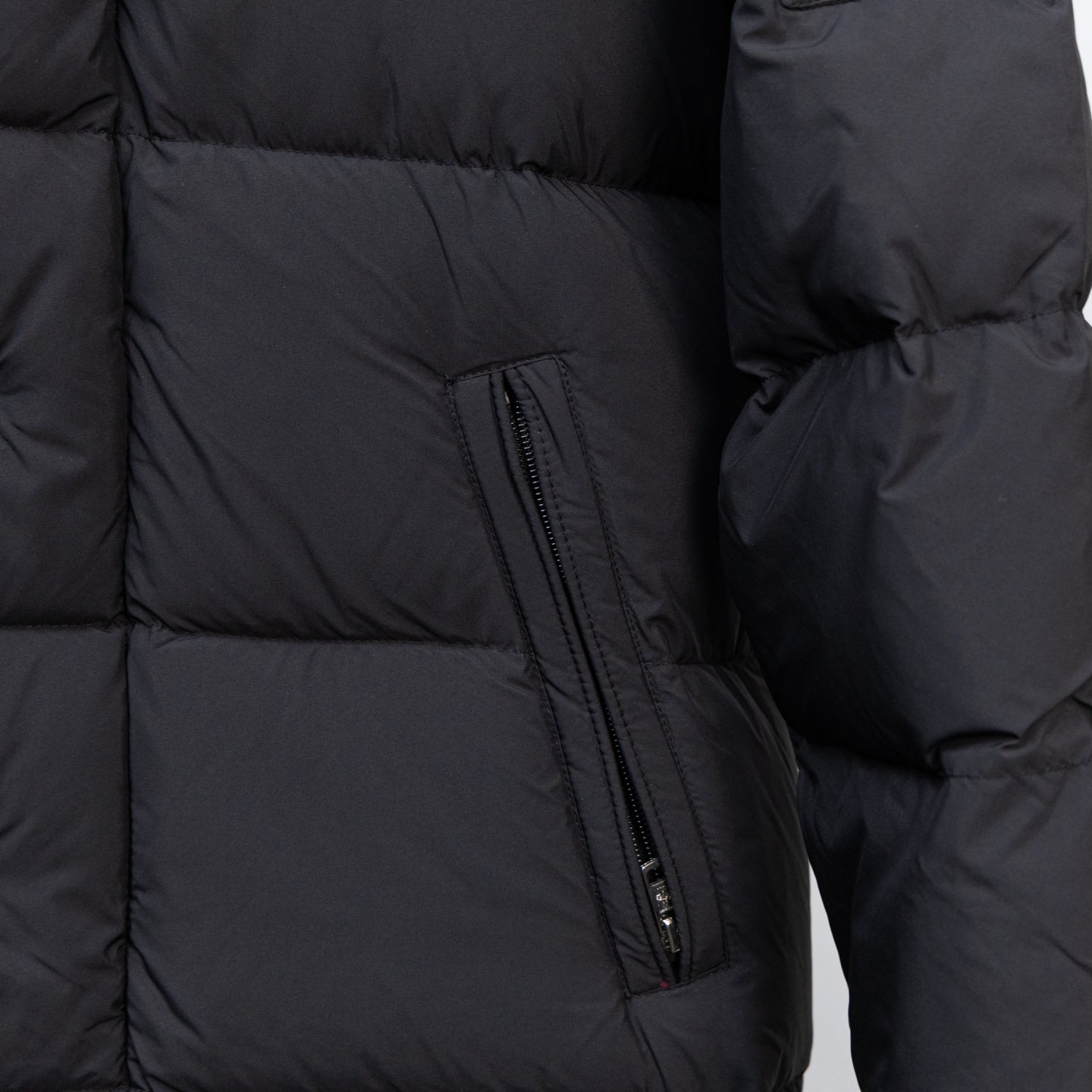 Moncler black puffer coat with side zip pocket and quilted panel