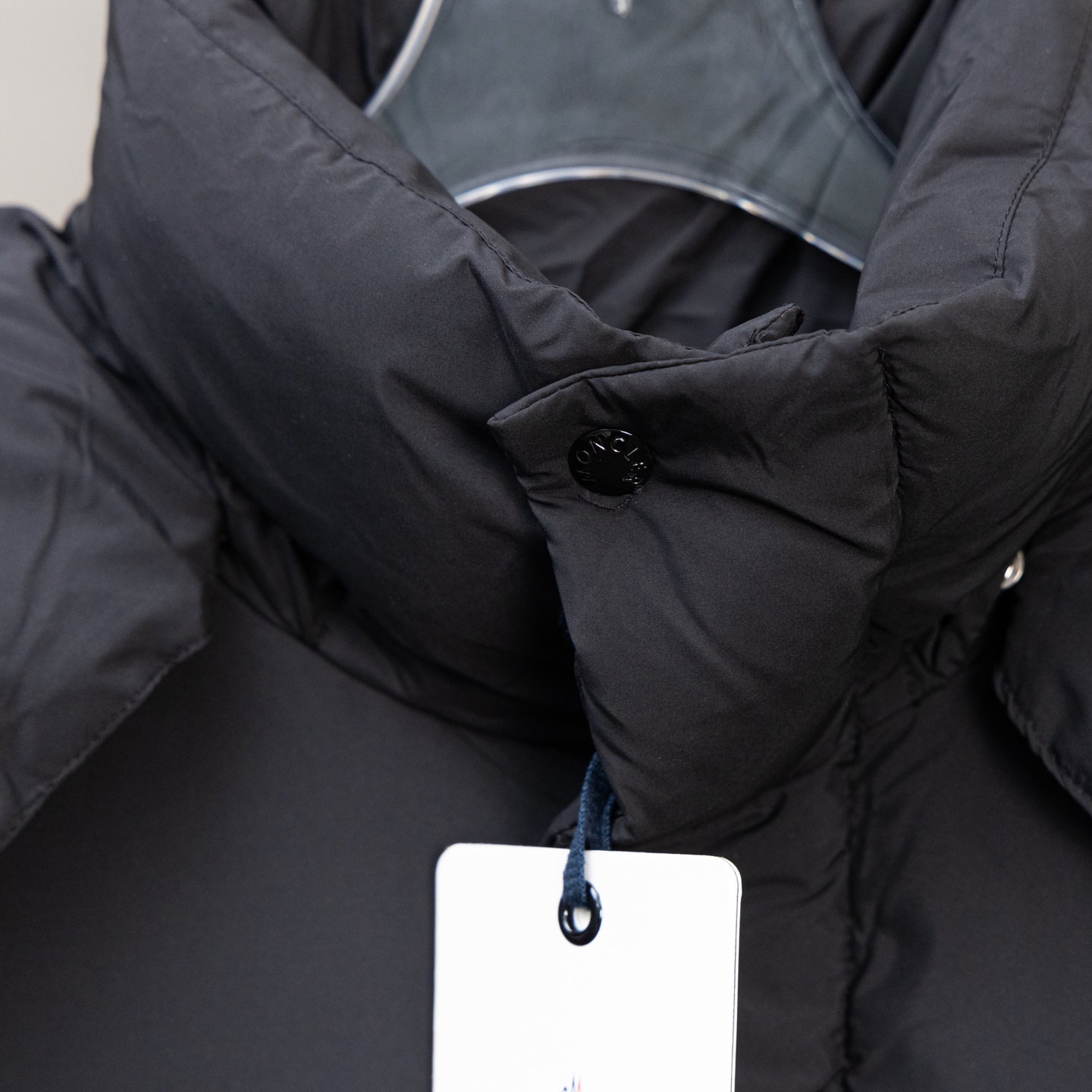 Moncler black puffer coat collar with snap button and inner hood fabric