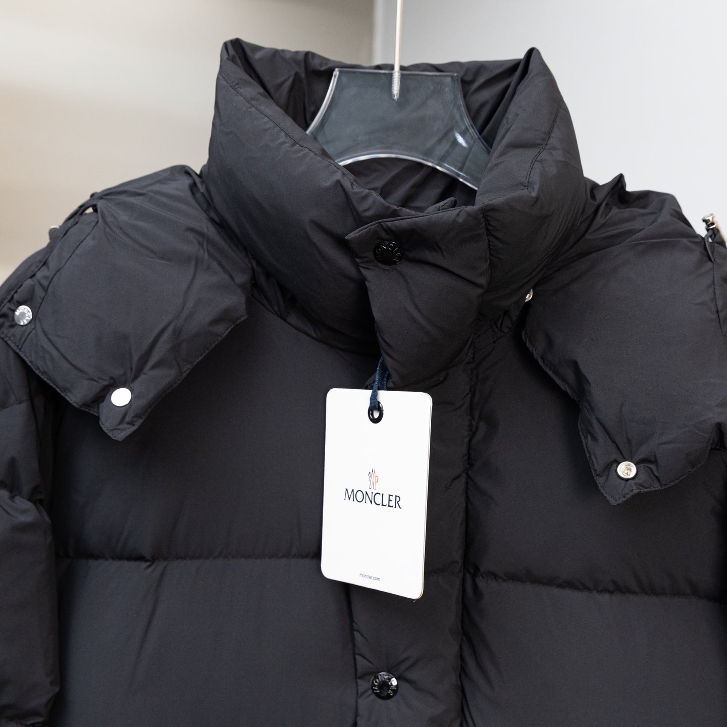 Moncler black hooded puffer coat with snap button placket and white size tag