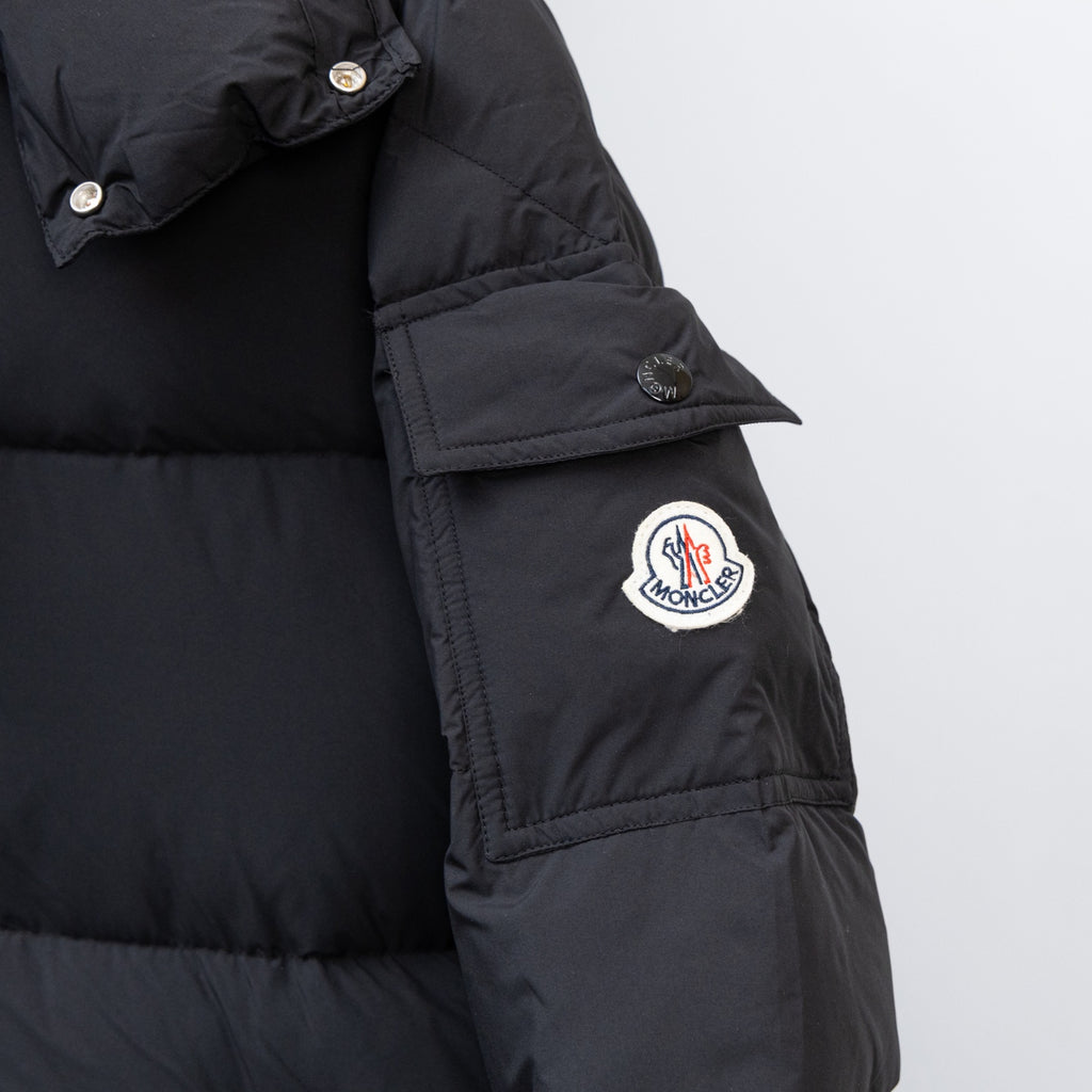 Moncler black puffer coat sleeve with round logo patch and snap cuff