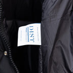 Black long puffer jacket with white brand label on inner lining
