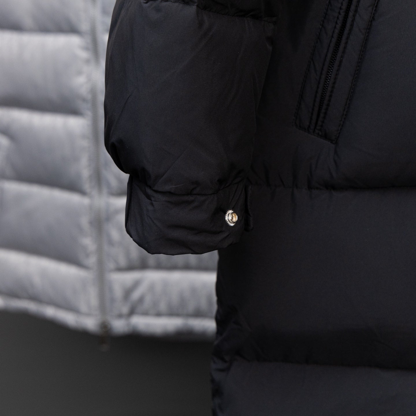 Black long puffer jacket cuff with snap button and dark zipper