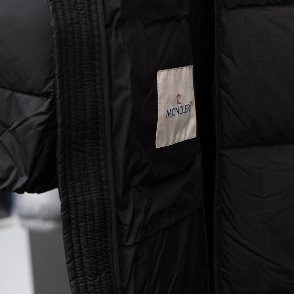 Moncler long puffer coat, black with vertical zip and Moncler logo patch