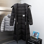Long Moncler puffer coat in black with hood and zip-front, side tie tabs