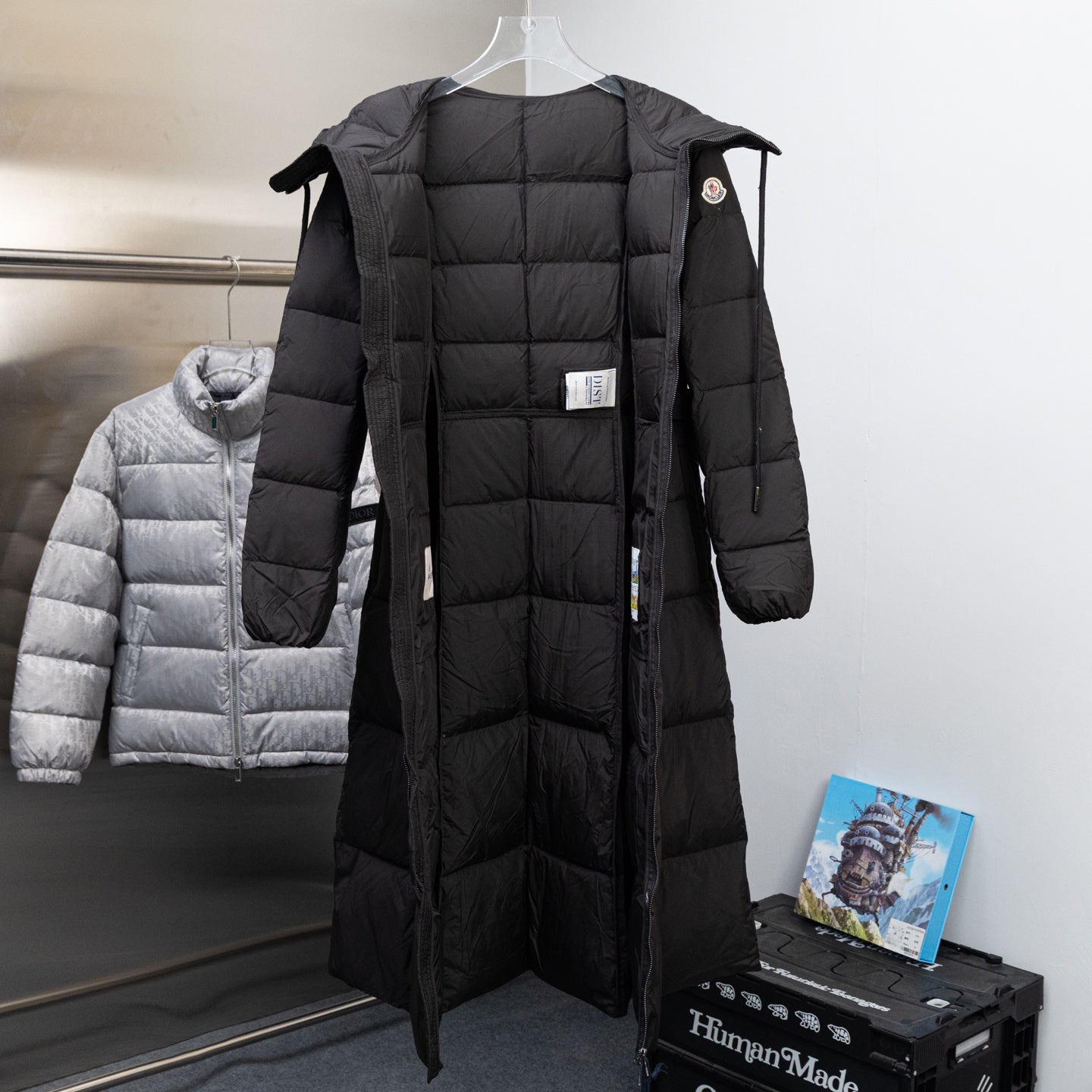 Long Moncler puffer coat in black with hood and zip-front, side tie tabs