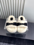 Balenciaga plush sandals pair on box with black strap buckles, cream shearling-look