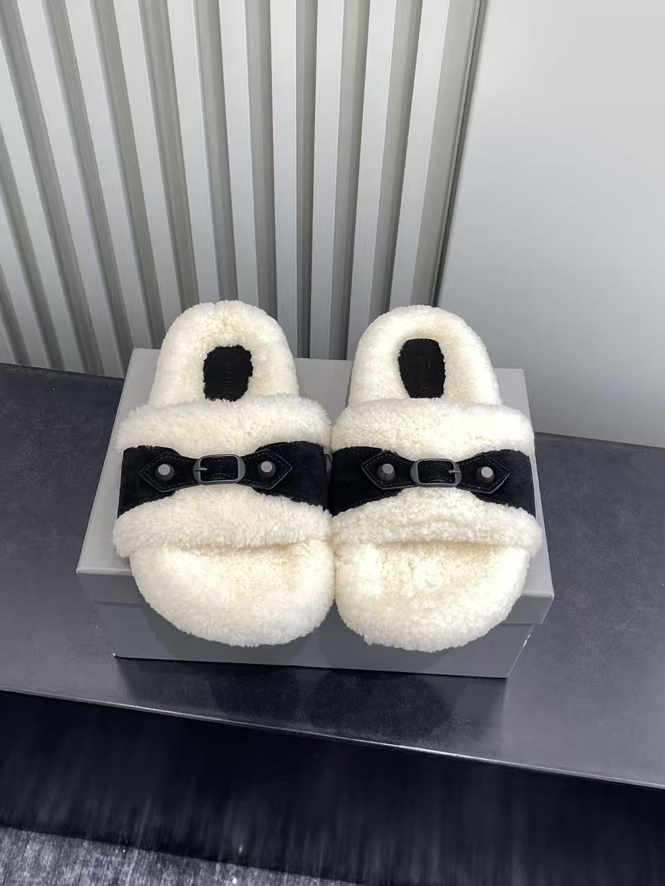 Balenciaga plush sandals pair on box with black strap buckles, cream shearling-look