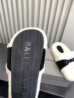Balenciaga plush sandal sole view with textured black tread and cream fuzzy upper