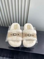 Cream fluffy slide sandals with tan cross strap and metal buckle, pair front view