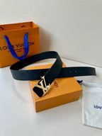 Dark leather belt with embossed monogram and gold-tone LV buckle, laid near box.