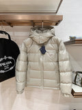 Long hooded puffer jacket in light beige, full-zip front with quilted baffles and logo patch