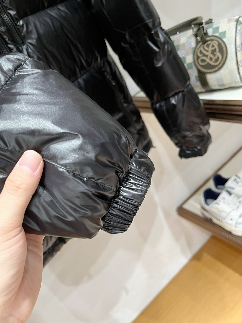 Black puffer jacket sleeve cuff with elastic hem