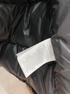 Black puffer jacket fabric with white care label tag