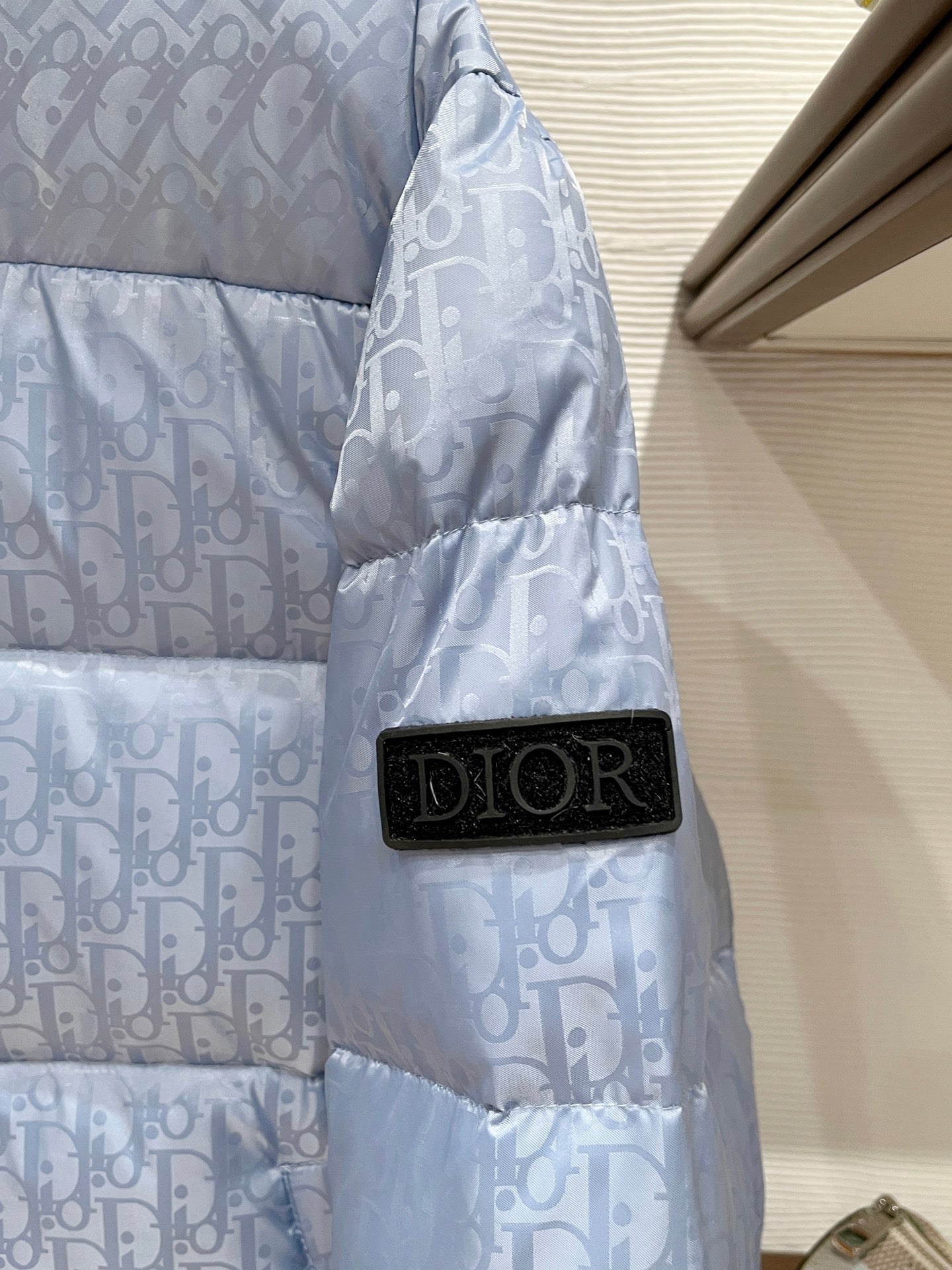 Dior long puffer jacket, light blue monogram sleeve with black Dior patch