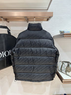 Black puffer jacket back view with quilted panels and high neck