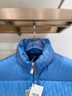 Blue quilted puffer vest with raised stand collar and front zipper close-up