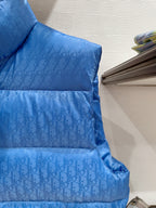 Blue quilted puffer vest with horizontal baffles and stand collar