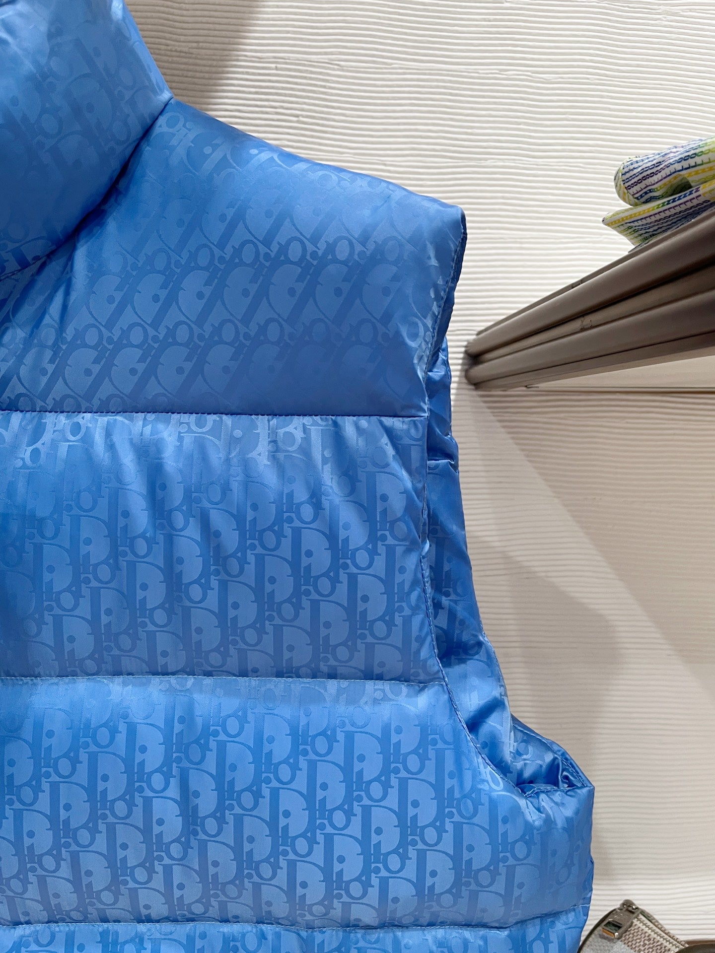 Blue quilted puffer vest with horizontal baffles and stand collar