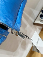 Blue puffer vest close-up with silver zipper pull and quilted panels