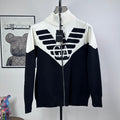 Two-tone knit zip-up sweater with ribbed turtleneck and bold logo graphic on chest