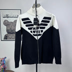 Two-tone knit zip-up sweater with ribbed turtleneck and bold logo graphic on chest