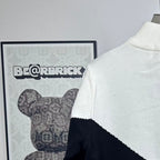 White and navy knit zip-up sweater with ribbed collar and back logo placement