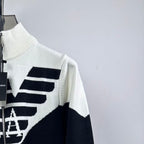 White and navy knit zip-up sweater with ribbed turtleneck and diagonal side logo