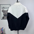Two-tone knit zip-up sweater with ribbed turtleneck and large back logo triangle