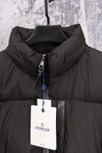 Black Moncler puffer jacket front with full zip, high collar, hanging tag