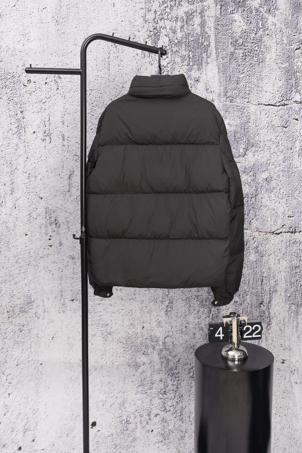 Long black puffer jacket with high neck and quilted baffles