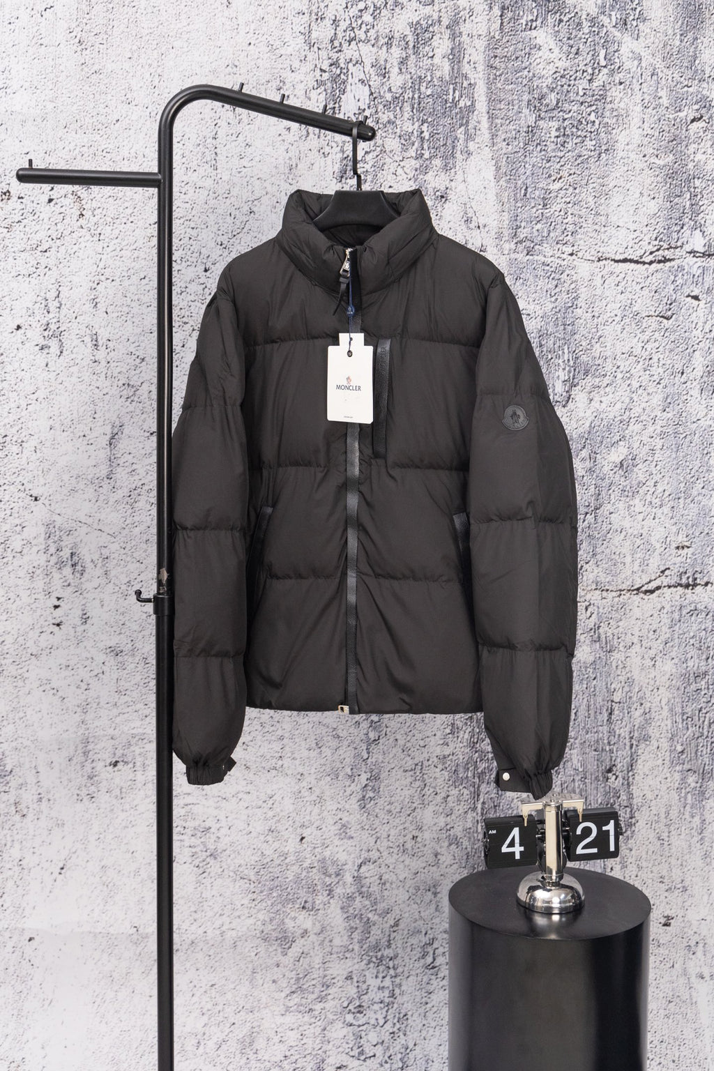 Long black puffer jacket with front zipper and stand collar