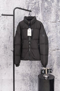 Long black puffer jacket with front zipper and stand collar