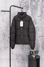 Long black puffer jacket with front zipper and stand collar