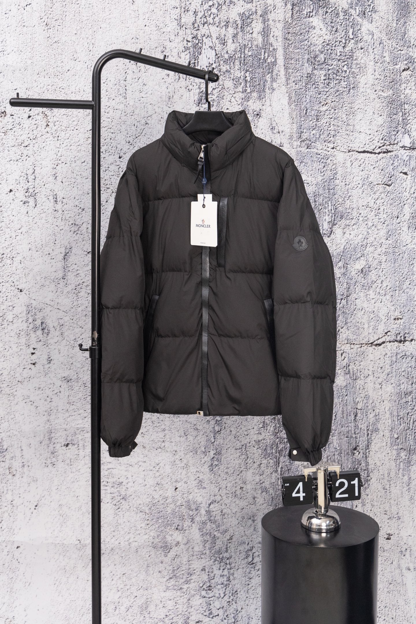 Long black puffer jacket with front zipper and stand collar