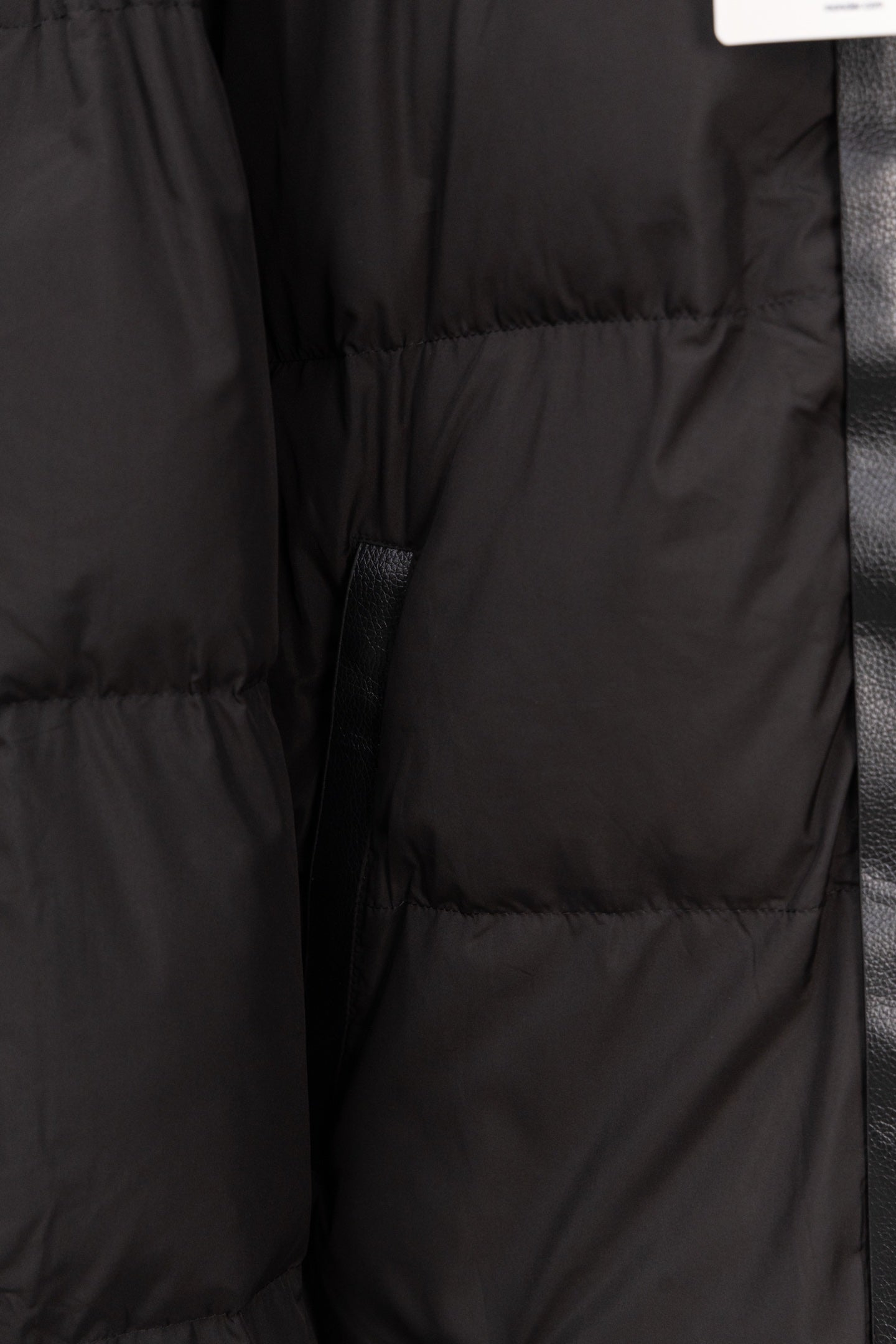 Long black puffer jacket quilted panels and buttoned placket