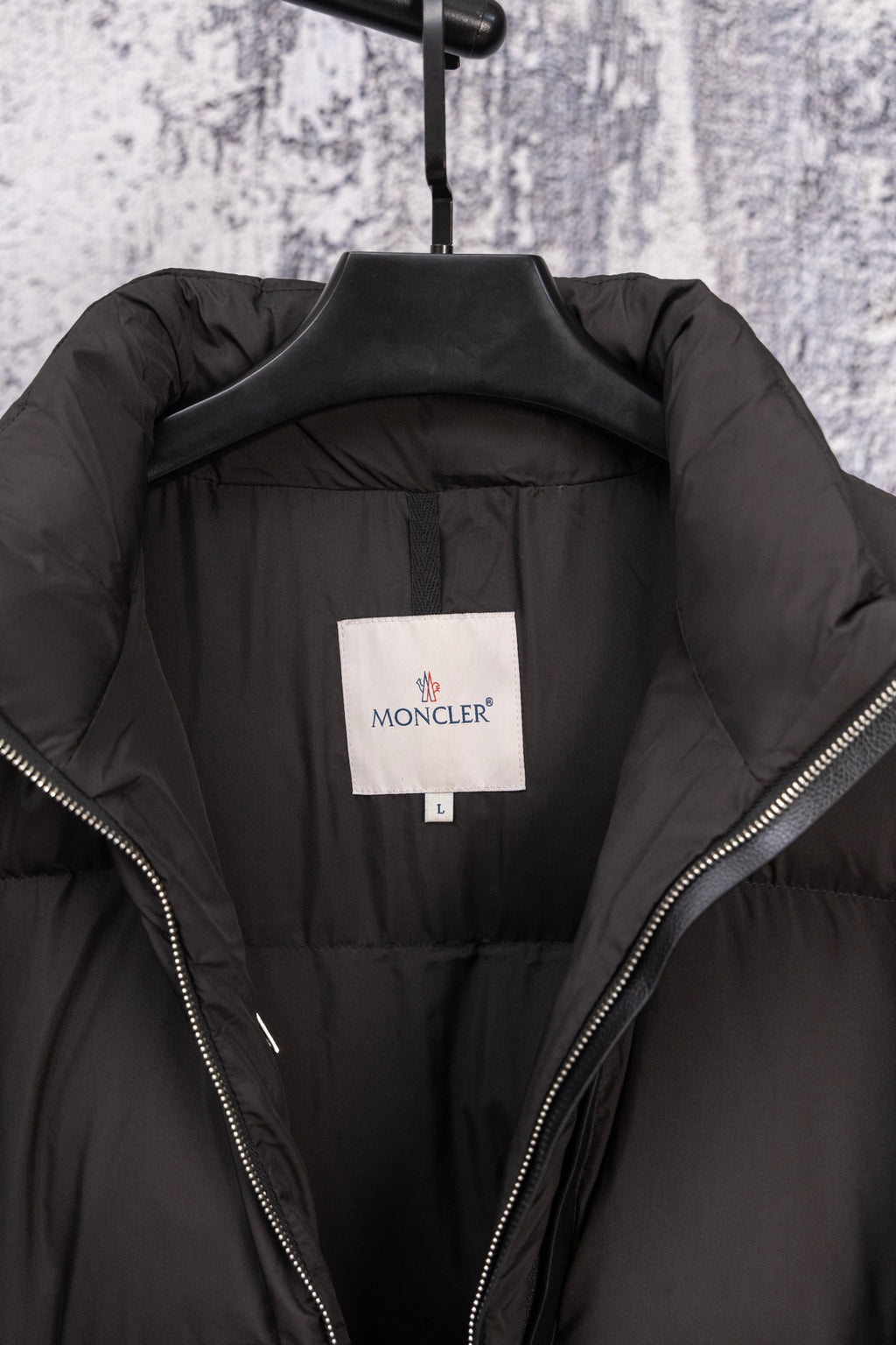 Long black puffer jacket lining with size label and zip edges