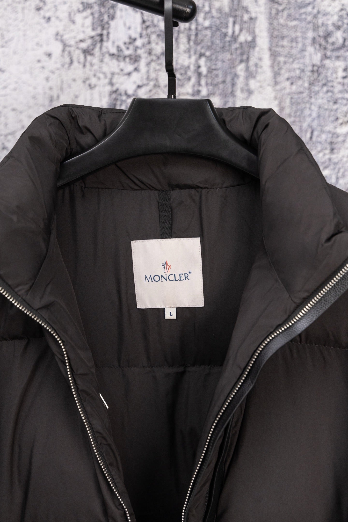 Long black puffer jacket lining with size label and zip edges