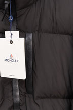 Long black puffer jacket pocket area with Moncler logo tag
