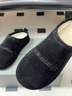 Balenciaga black suede slide sandals with embossed balenciaga logo on side