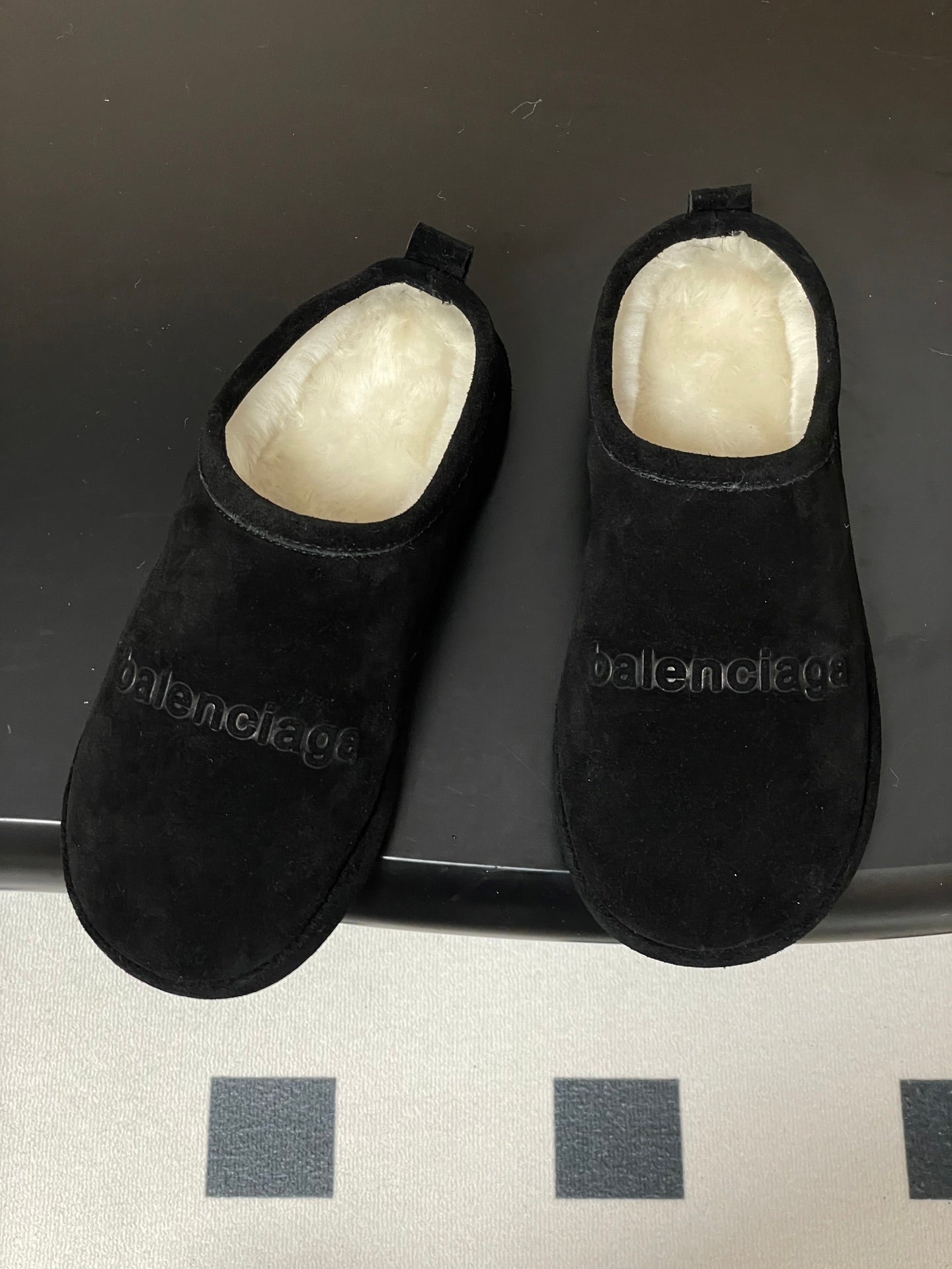 Balenciaga black suede slip-on sandals with cushioned white lining and side logo