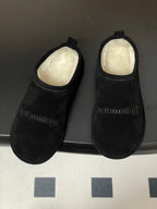 Balenciaga black suede slide sandals with light fleece lining and embossed logo