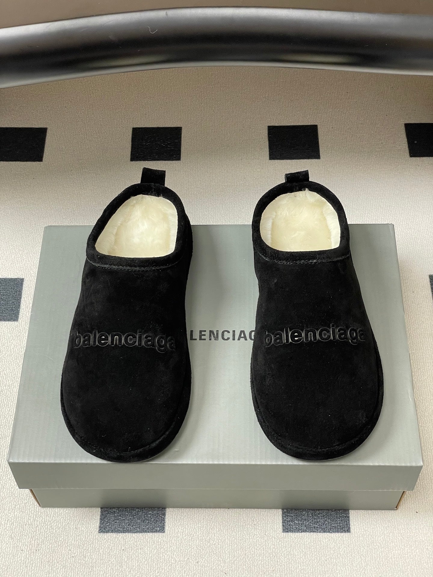 Balenciaga black suede slide sandals on box, fuzzy light lining visible