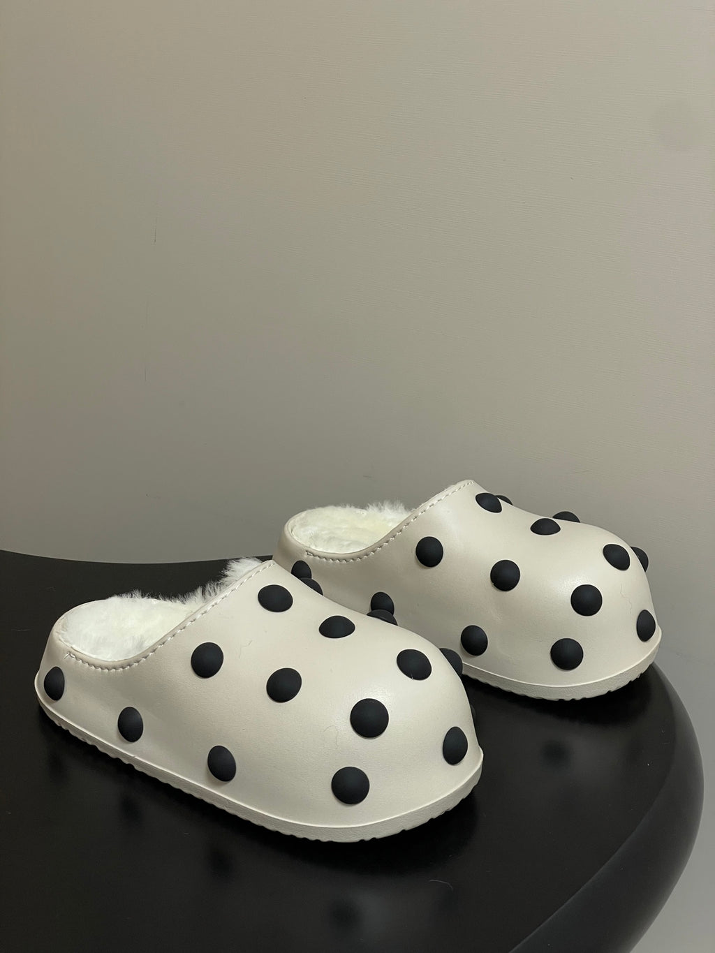 Cream polka-dot slip-on clogs with plush shearling lining and rounded toe