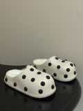 Cream polka-dot slip-on clogs with plush shearling lining and rounded toe